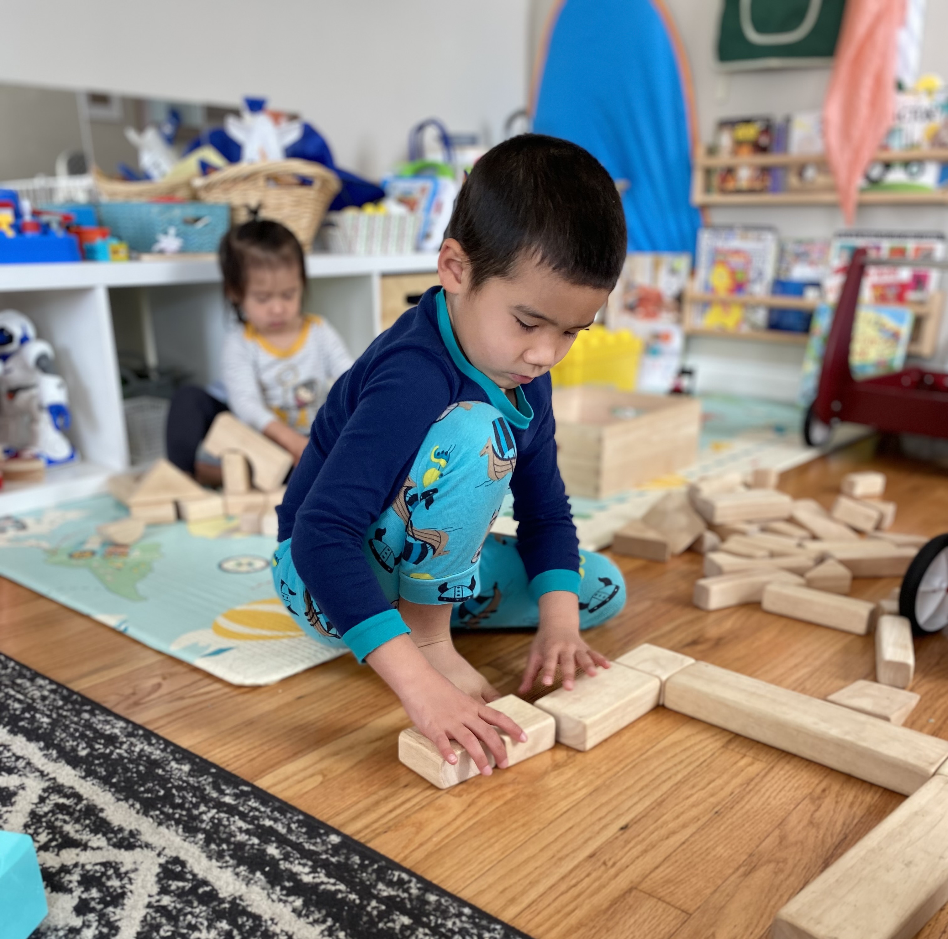 Two kids playing wit blocks independently 