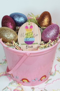 Large Easter basket for kids with personalized wooden Easter basket tag with a rainbow gradient bunny design, the words Happy Easter, & the child's name